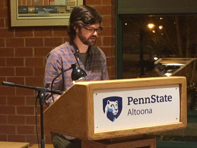 A student reading at the spring 2019 Hard Freight Cafe