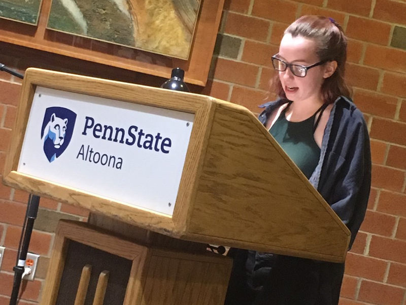 A student reading at the spring 2019 Hard Freight Cafe