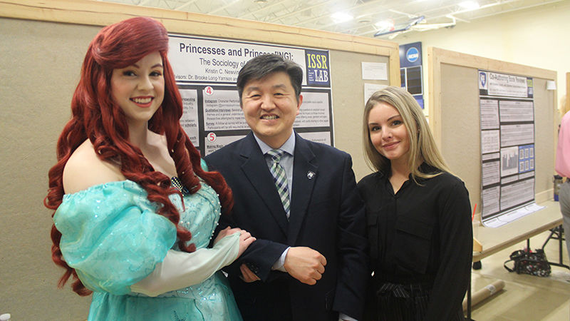 Student presenters Kristin Newvine and Peyton Loomis pose for a photo with Dr. Jungwoo Ryoo