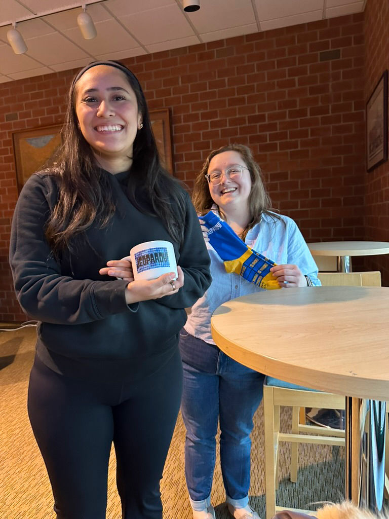 Participants in the Honors Program's Jeopardy night show off some swag.