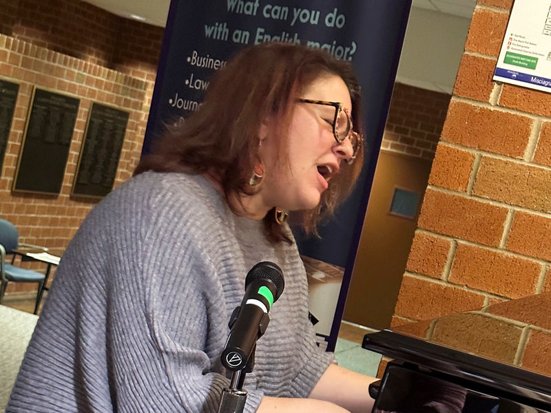 Jeannette Lang, assistant teaching professor of English, performs a song
