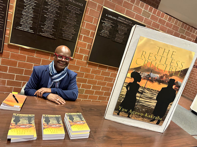 Yaw Agawu-Kakraba, professor of Spanish and African Studies, signs copies of his debut novel