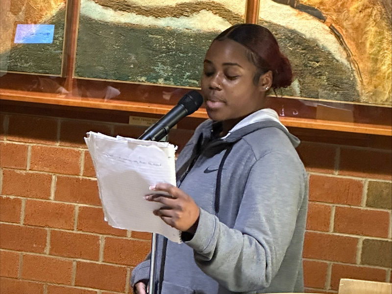 Student Nia Hubbard reads a poem.