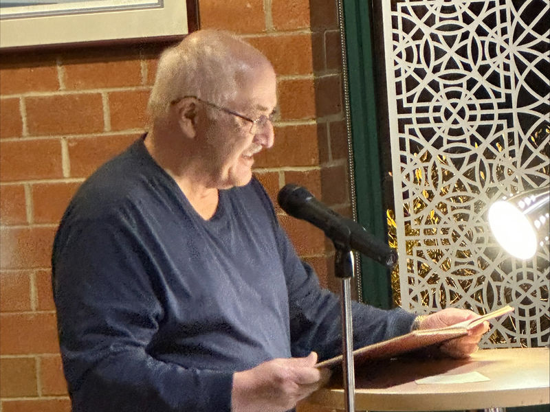 Tom Liszka, professor emeritus of English, reads a poem.