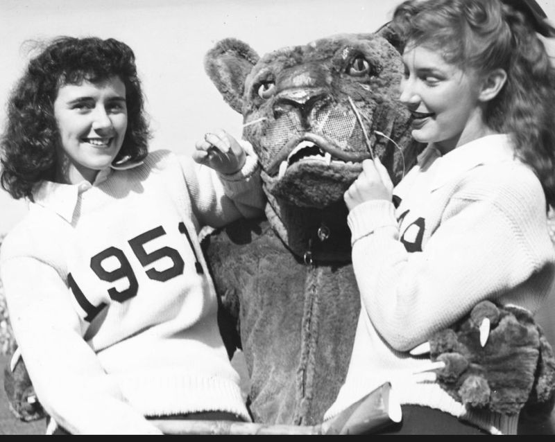 The Nittany Lion poses with two female cheerleaders in 1951.