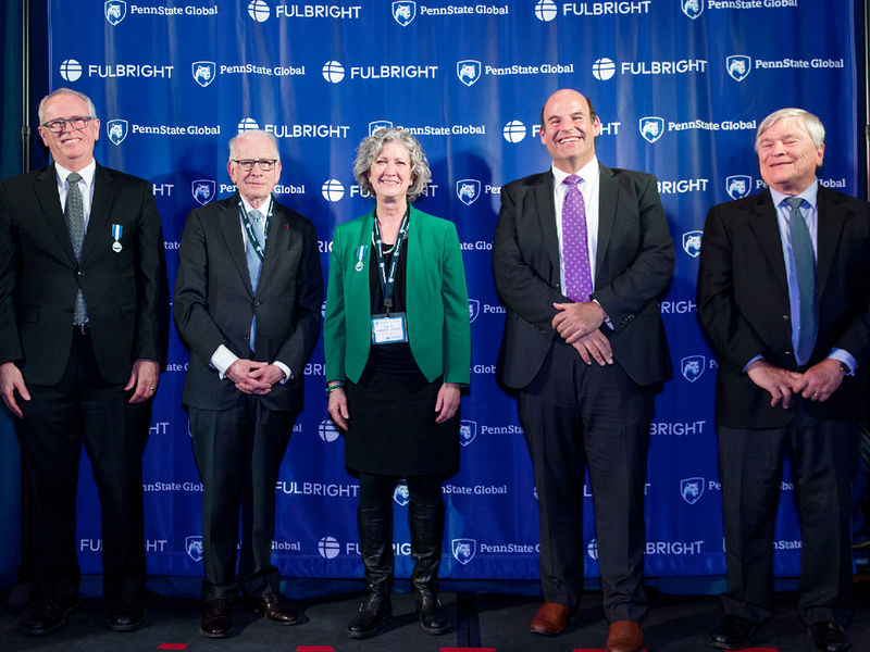 Distinguished Professor Sandy Petrulionis poses for a photo with Penn State administrators at a celebration of the 75th anniversary of the Fulbright program