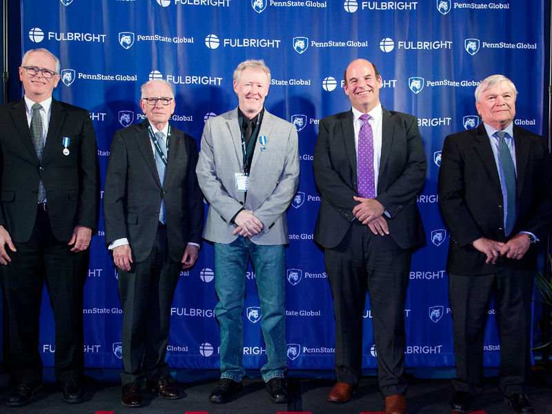 Professor Mark Agee poses for a photo with Penn State administrators at a celebration of the 75th anniversary of the Fulbright program