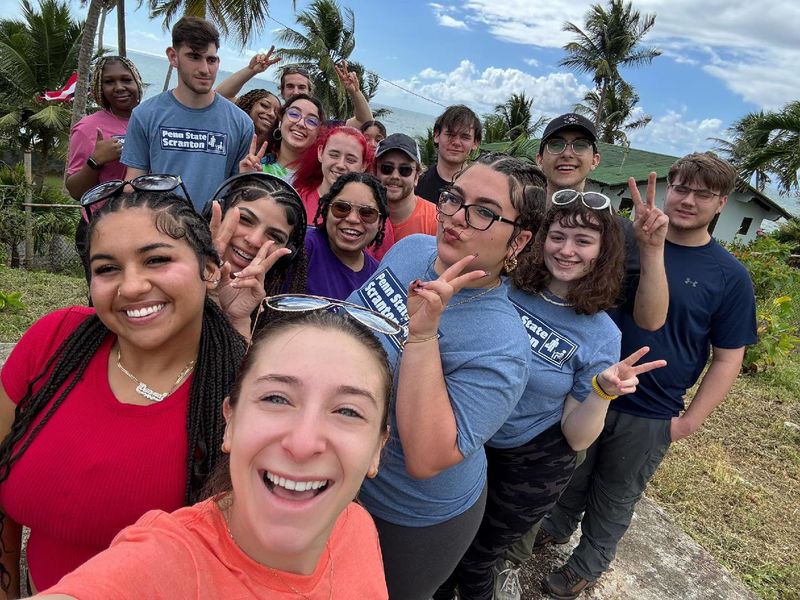 A group of students takes a selfie during a spring break trip to Puerto Rico