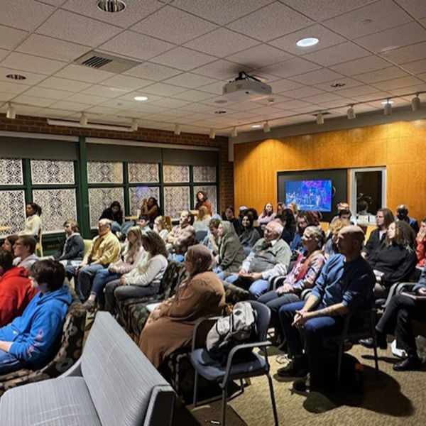 The audience enjoys the open mic event.