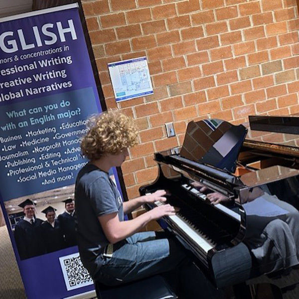 Levi Custer performs an original song on piano.