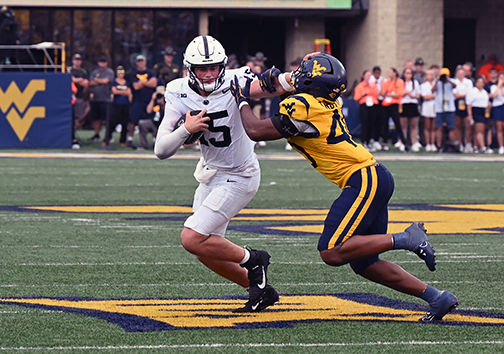 Drew Allar stiff arms West Virginia defender