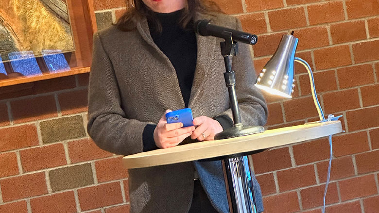 Student Ember Rose reads a poem