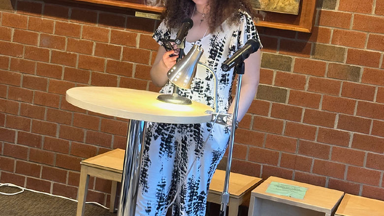 Student Emera Gregor reads an original short story