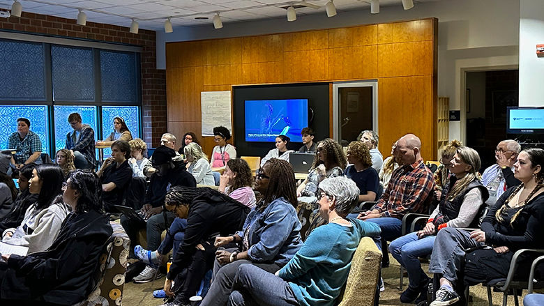 The audience listens to a musical performance.