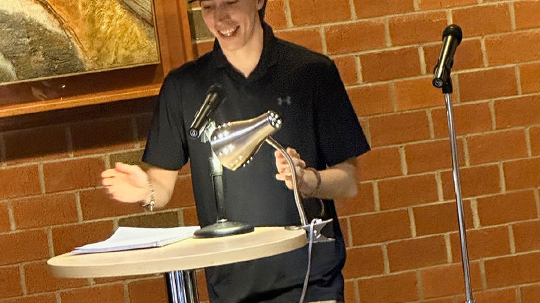Student Patrick Galante reads an original poem.