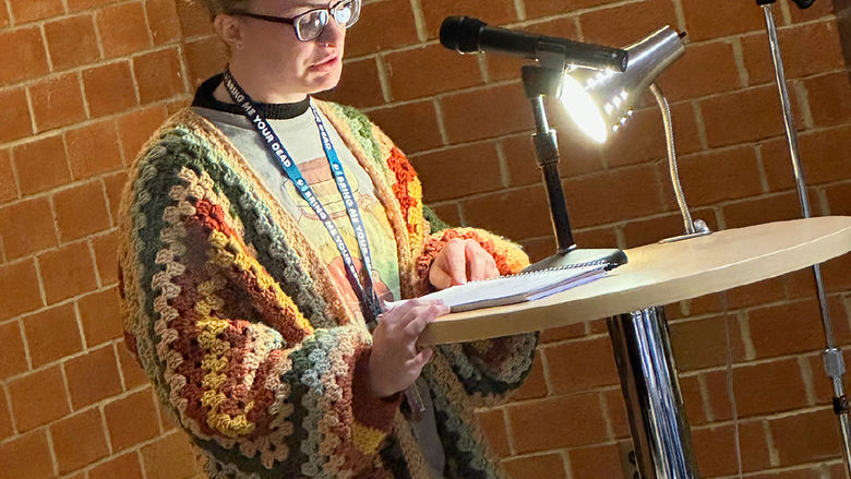 Student MiKayla Kelly reads an original poem.