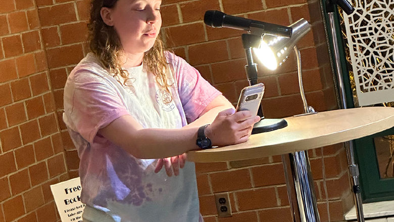 Student Bailee Seymour reads an original poem.