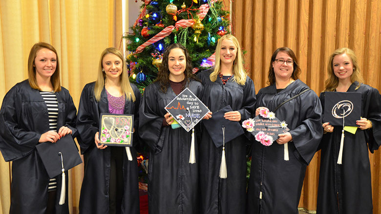 Graduates show off their cap decorations at Fall 2016 Commencement