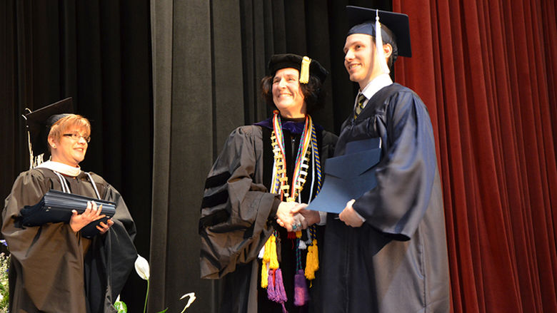 Chancellor and Dean Lori J. Bechtel-Wherry poses for a photo with a graduate