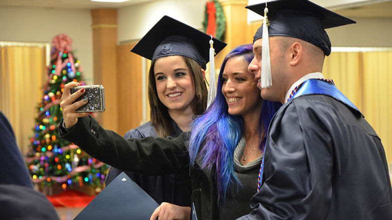 Posing for a photo after the Fall 2019 Commencement ceremony