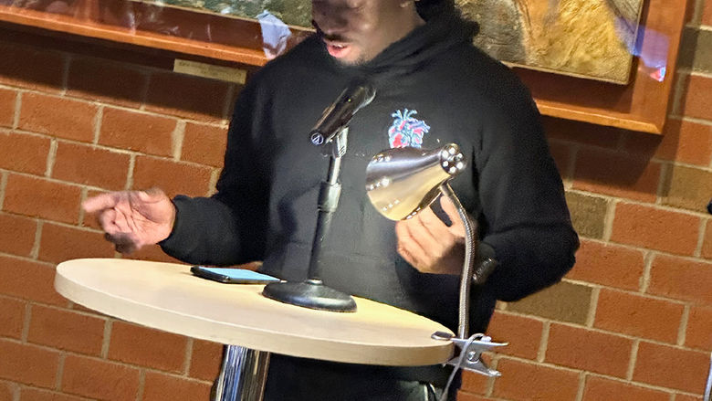 Student Darson Antoine reads an original poem.
