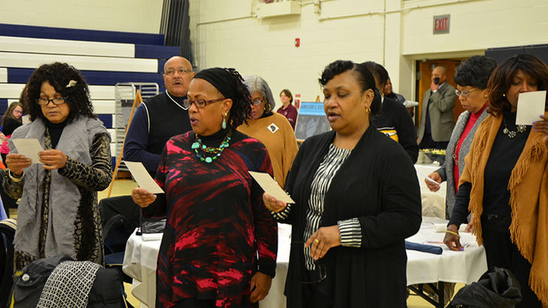 Audience members sing at the 2017 MLK Reflection Luncheon