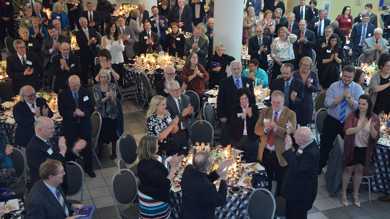 Guests offer a round of applause for C. David Kimmel
