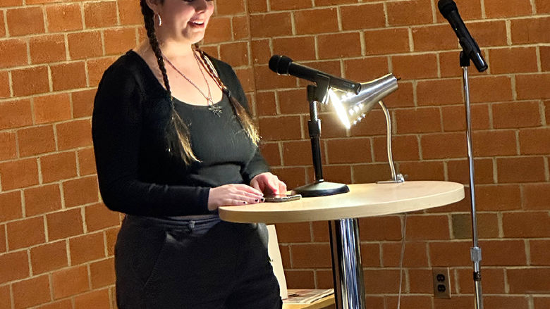 Student Piper Maxwell reads an original poem.