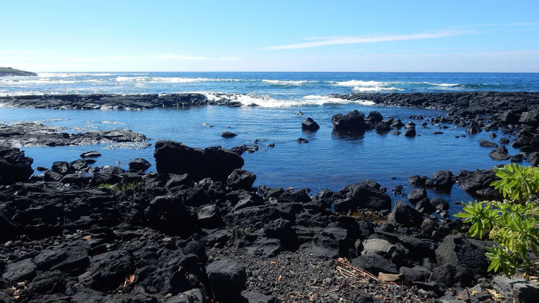 A black lava beach at Whittington Beach Park on the southern coast of the Big Island
