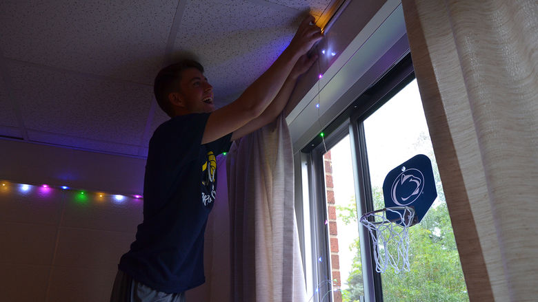 A student decorates their residence hall room