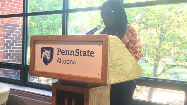 A faculty member reads from the work of Erin Kelly
