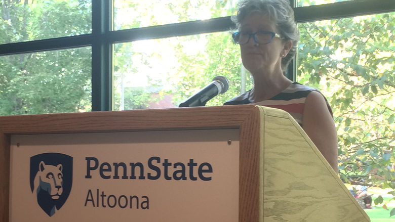 A faculty member reads from the work of Erin Kelly