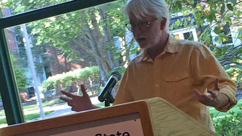 A faculty member reads from the work of Erin Kelly