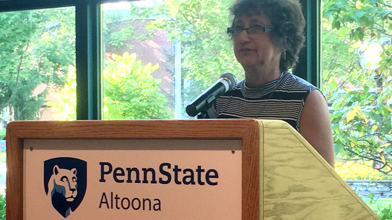 A faculty member reads from the work of Erin Kelly