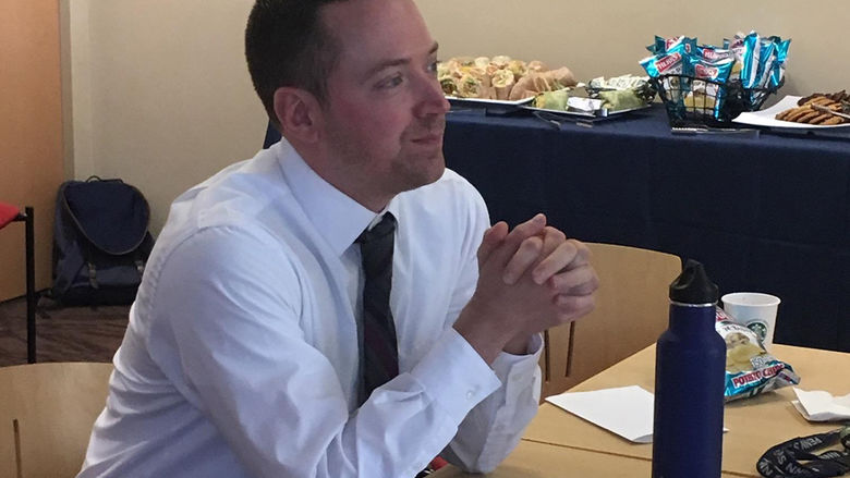 A faculty member observes senior English seminar presentations