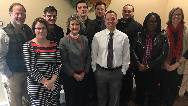 English faculty and seniors pose together following seminar presentations
