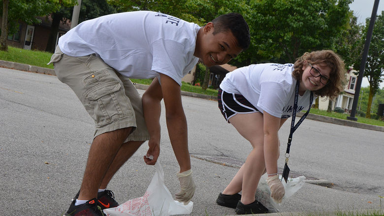 First year students clean up the street as part of Voluntoona
