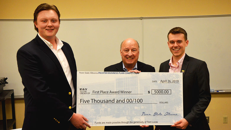 Steve Sheetz presents a check to the winners of the Pechter Business Plan Competition.