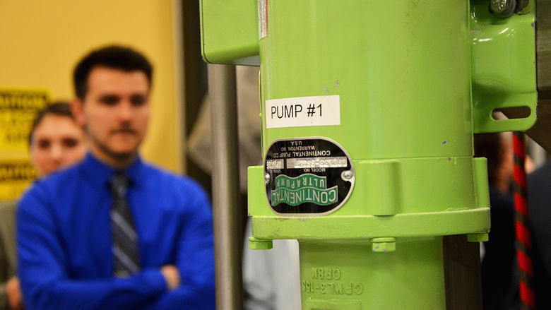 An engineering student presents a demonstration of his project.