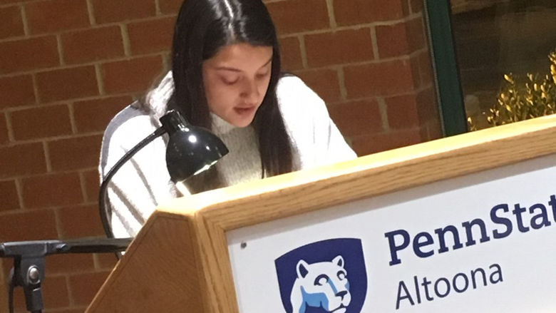 A student reading at the spring 2019 Hard Freight Cafe