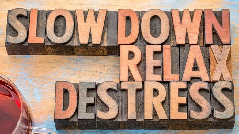 Block letters spelling out Slow Down, Relax, and Destress