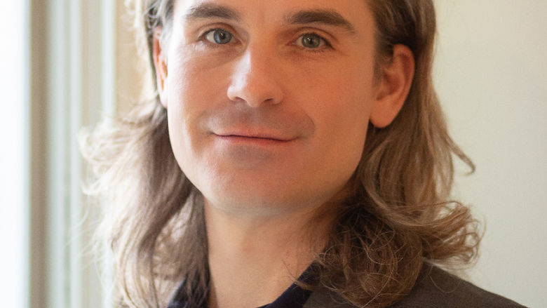 A headshot of John Eicher