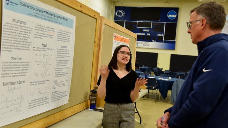Alexis Davidson explains her engineering and physical sciences research to Vice Chancellor of Academic Affairs Peter Hopsicker.