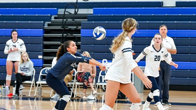 Penn State Altoona volleyball player hits a volleyball during a match