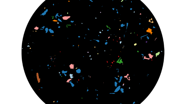 An LDIR image that shows the size, shape, and material characterizations of scanned microplastics that are between 10-990 um (microns).