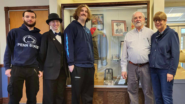 Left to right: Cinnsire Warner, Emma Moniz, Will Auman, Michael Halloran, and Debbie Canole stand at the new exhibit honoring John C. Halloran.