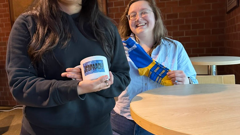 Participants in the Honors Program's Jeopardy night show off some swag.