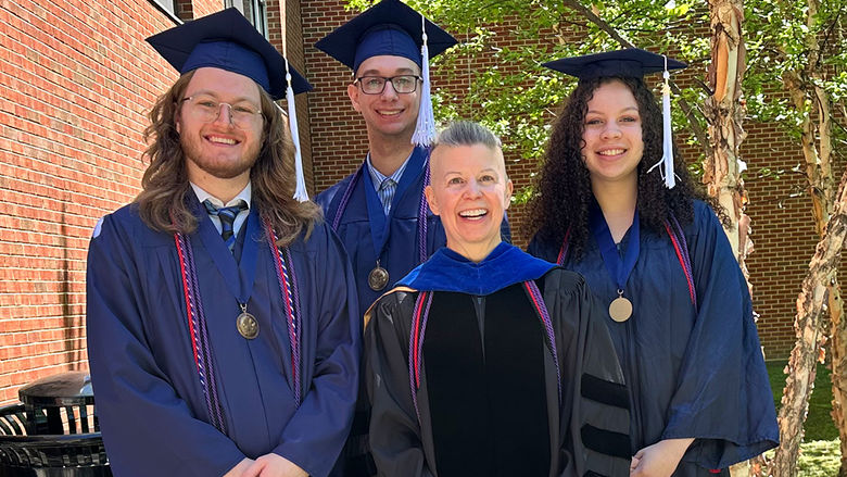 Dr. Laura Rotunno (center) with Schreyer Honors graduates (left to right) Travis Saylor, Logan Sava, and Emera Page.