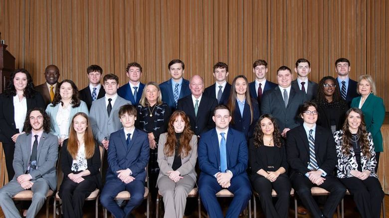 A group of students, faculty, staff and donors posing for a photo at the induction of the 14th class of Sheetz Fellows