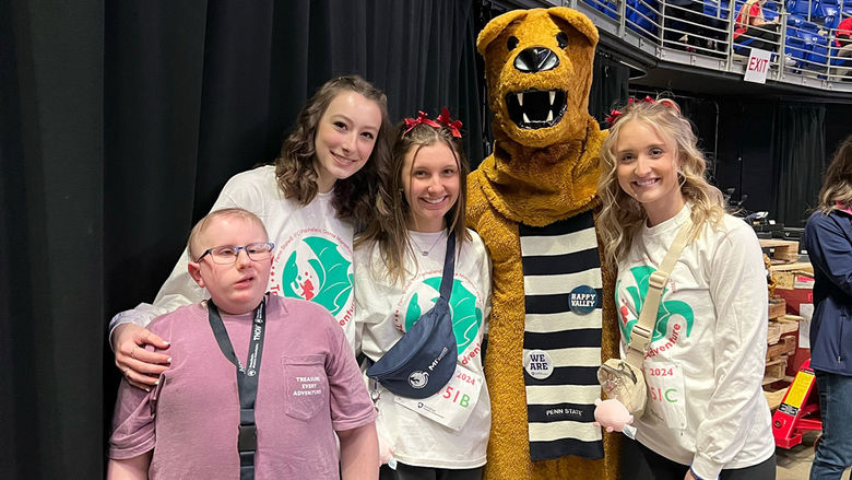 Neya, Caroline, Taylor, and the Nittany Lion with Neya’s younger brother, Collin, a cancer survivor and Four Diamonds child